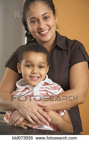Dominican mother hugging son View Large Photo Image Stock Photography - Dominican mother hugging son. Fotosearch