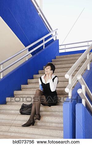 Hispanic businesswoman talking on cell phone outdoors View Large Photo Image Stock Photograph - Hispanic businesswoman talking on cell phone outdoors. Fotosearch