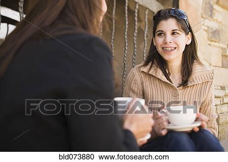 Middle Eastern mother and daughter drinking coffee View Large Photo Image Stock Image - Middle Eastern mother and daughter drinking coffee. Fotosearch