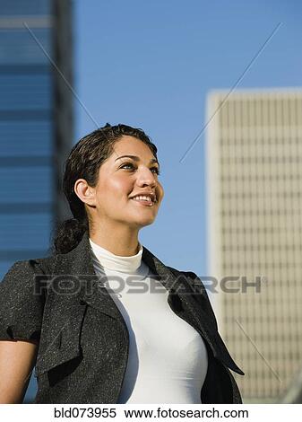 Stock Photography - Pregnant Middle Eastern woman standing in urban setting. Fotosearch
