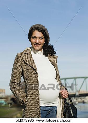 Pregnant Middle Eastern woman standing at waterfront View Large Photo Image Stock Photography - Pregnant Middle Eastern woman standing at waterfront. Fotosearch