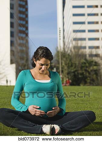 Pregnant Middle Eastern woman practicing yoga in park View Large Photo Image Stock Image - Pregnant Middle Eastern woman practicing yoga in park. Fotosearch