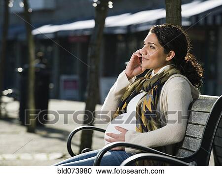Pregnant Middle Eastern woman talking on cell phone View Large Photo Image Stock Image - Pregnant Middle Eastern woman talking on cell phone. Fotosearch