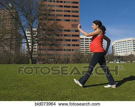 Pregnant Middle Eastern woman walking for exercise View Large Photo Image Picture - Pregnant Middle Eastern woman walking for exercise. Fotosearch