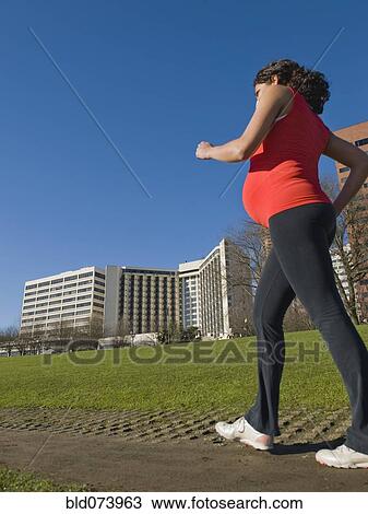 Pregnant Middle Eastern woman walking for exercise View Large Photo Image Stock Image - Pregnant Middle Eastern woman walking for exercise. Fotosearch