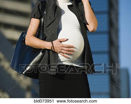 Pregnant woman rubbing stomach View Large Photo Image Stock Image - Pregnant woman rubbing stomach. Fotosearch