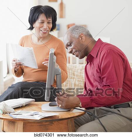 Stock Image - African couple assembling computer. Fotosearch