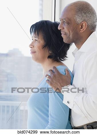 African couple looking out window View Large Photo Image Stock Photo - African couple looking out window. Fotosearch