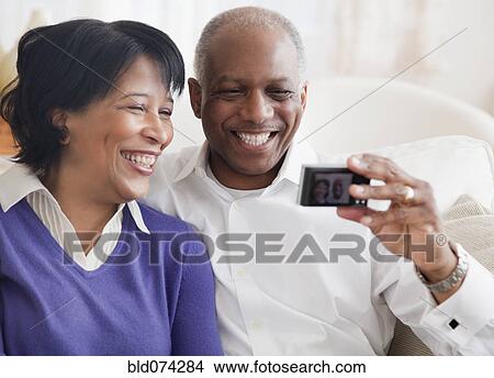 Picture - African couple taking self-portrait. Fotosearch