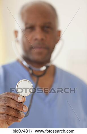 African doctor holding stethoscope View Large Photo Image Stock Photo - African doctor holding stethoscope. Fotosearch