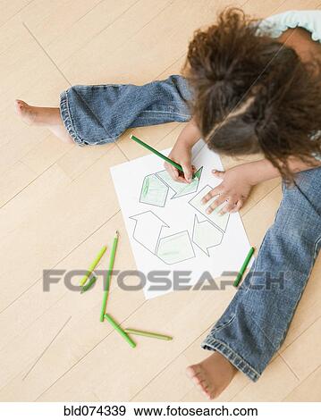 Stock Photo - African girl coloring recycling symbol. Fotosearch