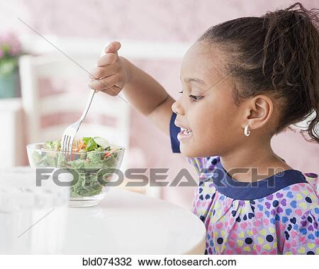 African girl eating salad View Large Photo Image Stock Image - African girl eating salad. Fotosearch