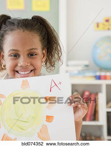 Stock Image - African girl with A plus on painting. Fotosearch