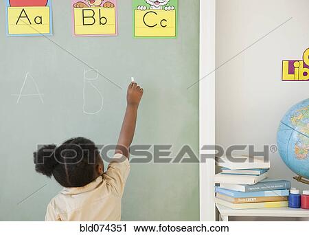 African girl writing on blackboard View Large Photo Image Stock Image - African girl writing on blackboard. Fotosearch