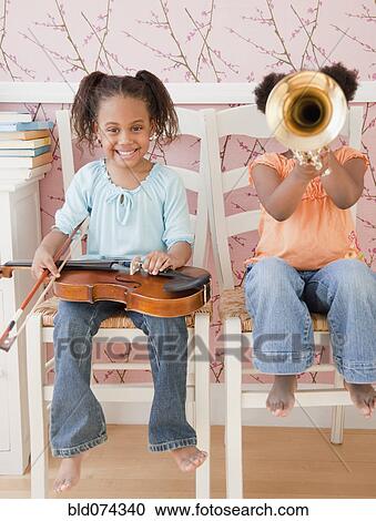 Stock Image - African girls playing instruments. Fotosearch
