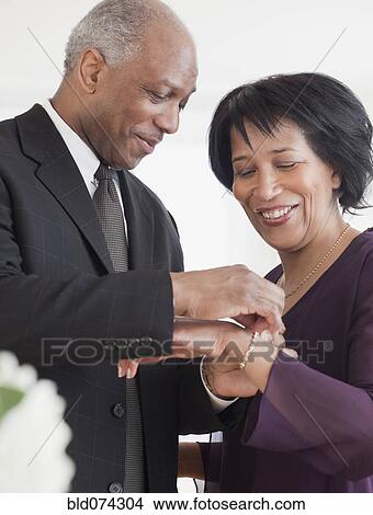African man attaching bracelet for wife View Large Photo Image Picture - African man attaching bracelet for wife. Fotosearch