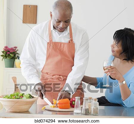 African man preparing dinner for wife View Large Photo Image Picture - African man preparing dinner for wife. Fotosearch