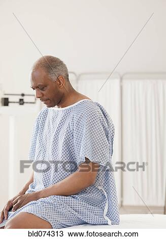 Stock Image - African man waiting for doctor in hospital. Fotosearch