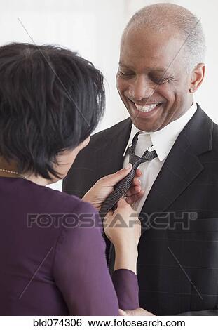 African woman adjusting husband's tie View Large Photo Image Stock Photograph - African woman adjusting husband's tie. Fotosearch