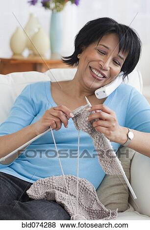 African woman talking on the phone and knitting View Large Photo Image Stock Photo - African woman talking on the phone and knitting. Fotosearch