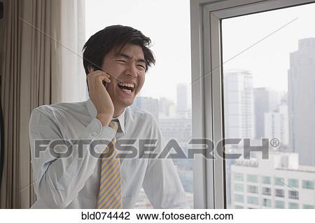 Chinese businessman talking on cell phone View Large Photo Image Stock Image - Chinese businessman talking on cell phone. Fotosearch
