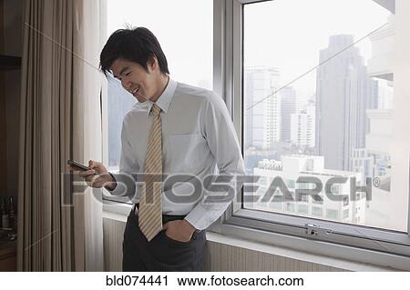 Chinese businessman using cell phone View Large Photo Image Stock Image - Chinese businessman using cell phone. Fotosearch