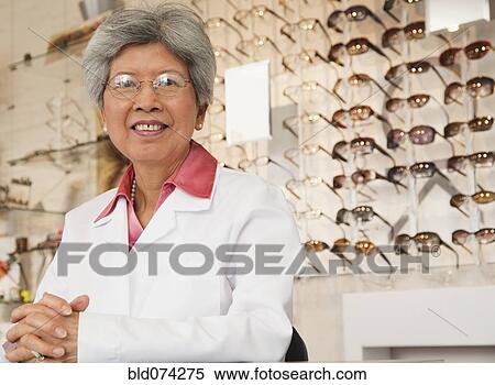 Chinese optician standing in store View Large Photo Image Stock Photography - Chinese optician standing in store. Fotosearch