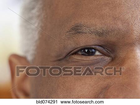 Stock Image - Close up of African man's eye. Fotosearch