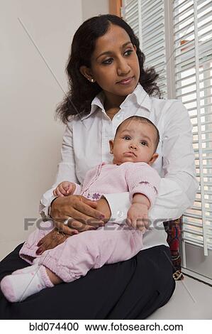 Indian mother holding baby View Large Photo Image Stock Image - Indian mother holding baby. Fotosearch