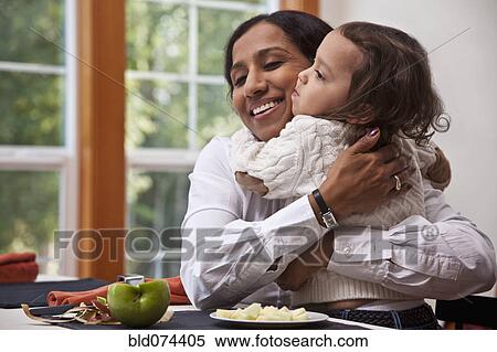 Stock Photography - Indian mother hugging daughter. Fotosearch