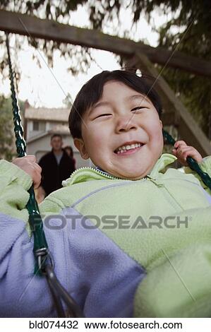 Korean boy swinging View Large Photo Image Stock Image - Korean boy swinging. Fotosearch
