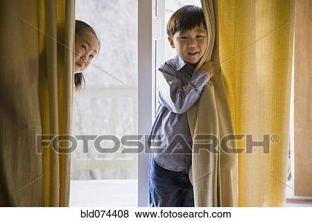 Stock Photo - Korean children behind curtains. Fotosearch