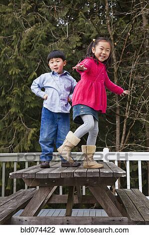 Korean children playing on picnic bench View Large Photo Image Stock Image - Korean children playing on picnic bench. Fotosearch