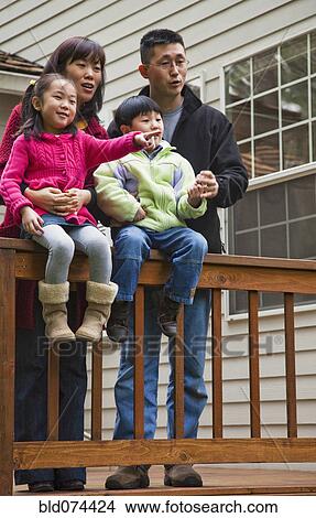 Picture - Korean family on patio. Fotosearch
