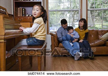 Picture - Korean girl playing piano. Fotosearch