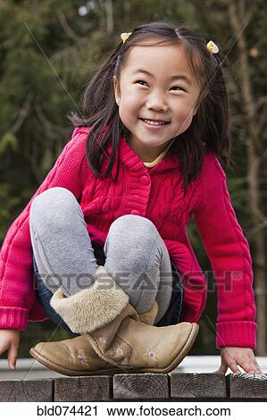 Korean girl sitting on picnic bench View Large Photo Image Stock Image - Korean girl sitting on picnic bench. Fotosearch