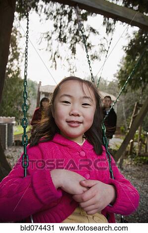 Stock Image - Korean girl swinging. Fotosearch