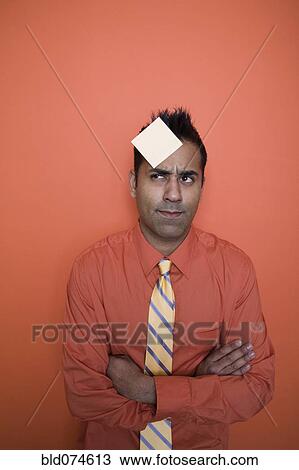 Mixed race businessman with sticky note on forehead View Large Photo Image Stock Image - Mixed race businessman with sticky note on forehead. Fotosearch