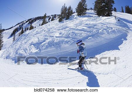 Stock Photo - Mixed race girl skiing downhill. Fotosearch