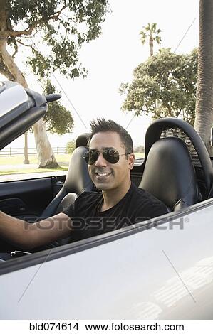 Mixed race man driving convertible View Large Photo Image Picture - Mixed race man driving convertible. Fotosearch