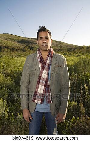 Stock Photo - Mixed race standing in field. Fotosearch