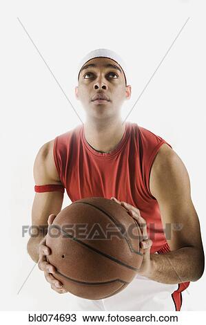 Stock Image - African basketball player ready to shoot basketball. Fotosearch