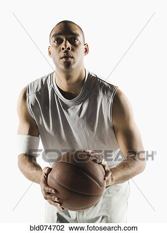 Stock Image - African basketball player ready to shoot basketball. Fotosearch