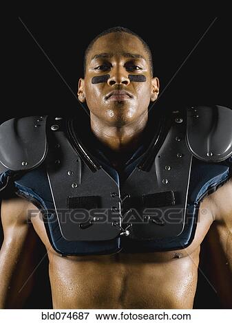 Stock Photo - African football player wearing protective pads. Fotosearch