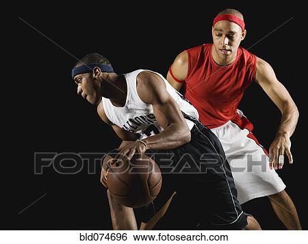 Stock Photograph - African men playing basketball. Fotosearch