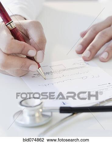 Stock Image - Doctor writing prescription. Fotosearch