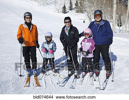 Picture - Family preparing to go skiing. Fotosearch