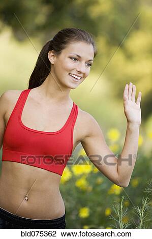 Hispanic woman in sports bra waving View Large Photo Image Stock Image - Hispanic woman in sports bra waving. Fotosearch