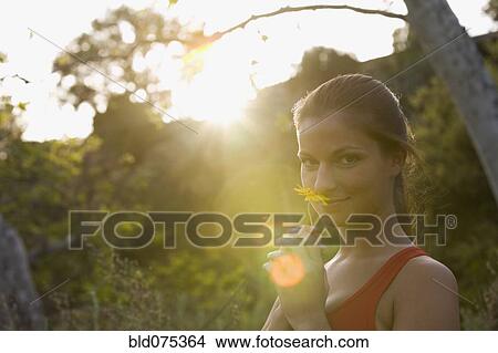 Hispanic woman smelling flower View Large Photo Image Picture - Hispanic woman smelling flower. Fotosearch