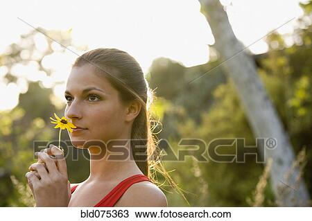 Hispanic woman smelling flower View Large Photo Image Stock Image - Hispanic woman smelling flower. Fotosearch